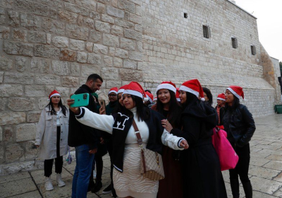 Tourists heading for the Church of Nativity in Bethlehem gather for a selfie